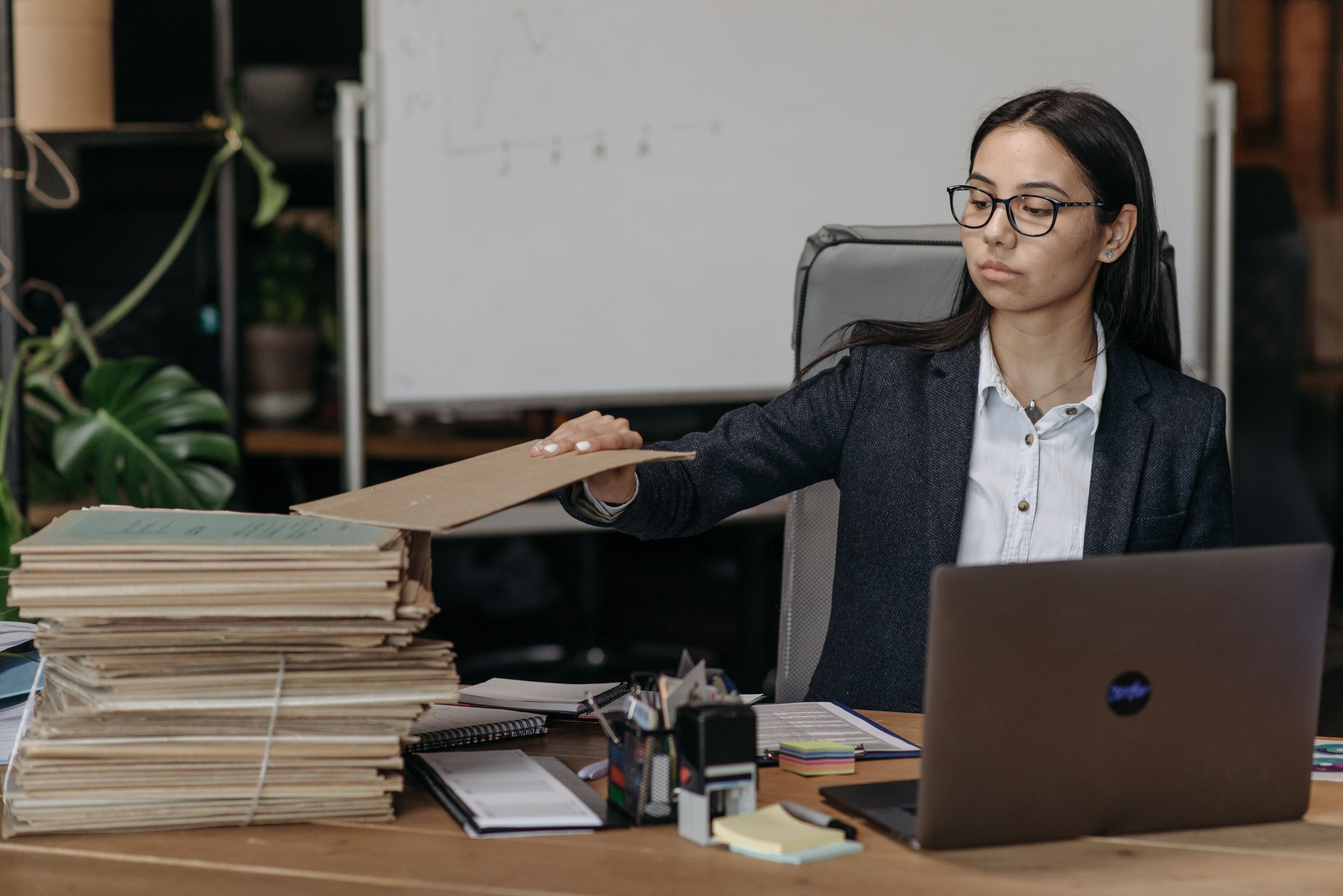 Femme d'affaires organisant une pile de dossiers